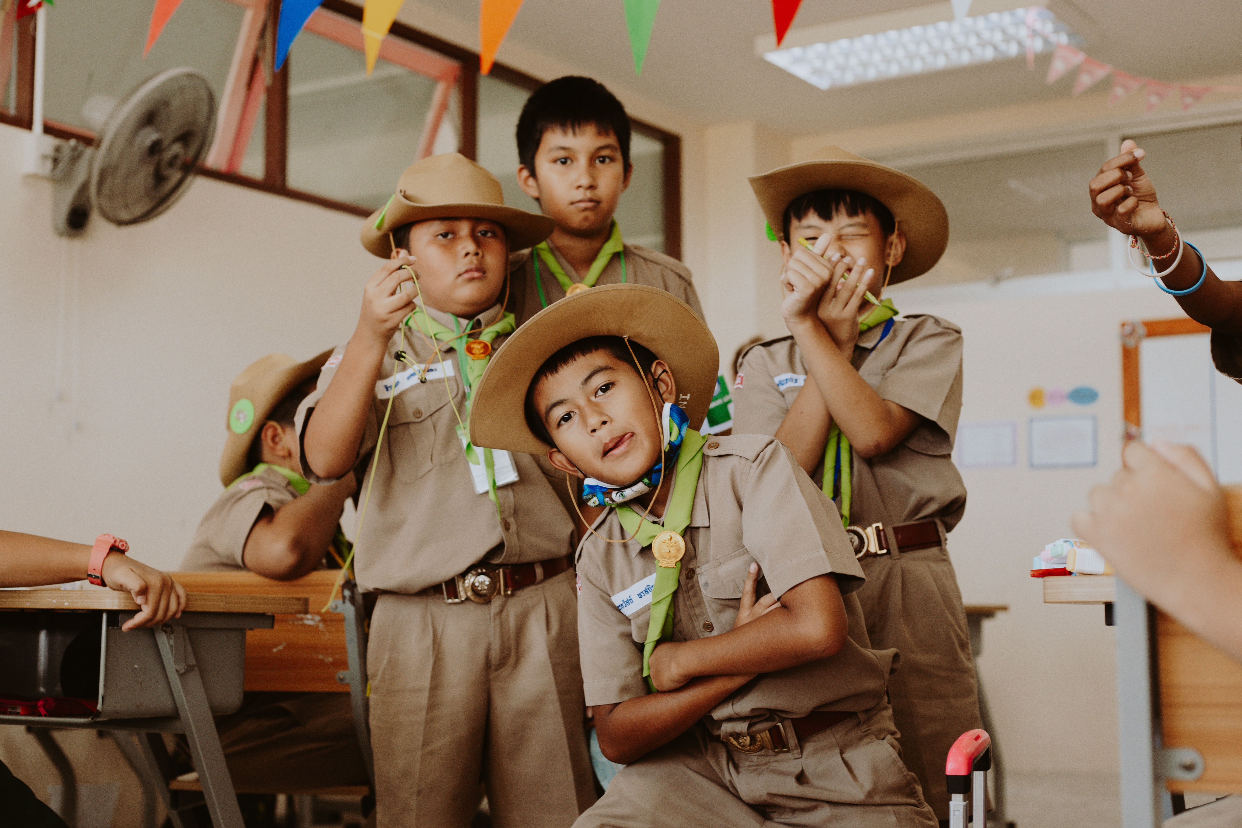 group of children posing for the camera in scouts uniforms